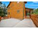Log cabin exterior with a concrete patio, wood fence, and natural surroundings at 4830 Silver Tip Way, Mount Charleston, NV 89124