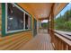 Charming log cabin home featuring a wood porch with views of the surrounding mountains and trees at 4830 Silver Tip Way, Mount Charleston, NV 89124