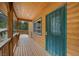 Inviting log cabin home featuring a wood porch with a green security door at 4830 Silver Tip Way, Mount Charleston, NV 89124