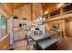 Rustic kitchen features wood cabinets, stone countertops, and an island with seating at 4830 Silver Tip Way, Mount Charleston, NV 89124