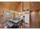 Cozy kitchen with wood paneling, light wood cabinets, granite countertops, and stainless steel appliances at 4830 Silver Tip Way, Mount Charleston, NV 89124