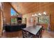 Open-concept living room with wood paneling, fireplace, and dining area at 4830 Silver Tip Way, Mount Charleston, NV 89124