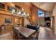 Spacious living room with a wood burning fireplace, wood paneling, and a cozy seating area at 4830 Silver Tip Way, Mount Charleston, NV 89124