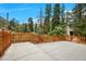 Concrete patio with a wood fence and lush greenery creating a secluded outdoor space at 4830 Silver Tip Way, Mount Charleston, NV 89124
