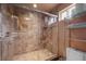 The walk in shower features beautiful tiling and an updated shower head at 4830 Silver Tip Way, Mount Charleston, NV 89124