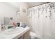 Bathroom featuring sink, toilet, vanity and an ornate shower curtain at 521 Landra Ln, Henderson, NV 89015