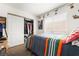 Bright bedroom with colorful bedding, window and closet with open doors at 521 Landra Ln, Henderson, NV 89015