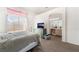 Bright bedroom featuring a bed, a view to the backyard and an archway into the bathroom at 521 Landra Ln, Henderson, NV 89015