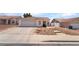 Charming single-story home featuring a two-car garage and low maintenance desert landscaping at 521 Landra Ln, Henderson, NV 89015
