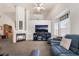 Open living room featuring neutral color palette, vaulted ceilings, and fireplace at 521 Landra Ln, Henderson, NV 89015