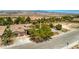 Beautiful aerial view of a single-story home with lush landscaping and mountain views at 5396 Splendido Ave, Pahrump, NV 89061