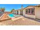 Beautiful backyard features a swimming pool, spa, covered patio, and ample space for recreation at 5396 Splendido Ave, Pahrump, NV 89061