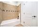 Bathroom with a shower-tub combo and tiled surround at 5396 Splendido Ave, Pahrump, NV 89061