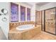 Bathroom featuring a soaking tub, a shower, and windows with wooden blinds at 5396 Splendido Ave, Pahrump, NV 89061