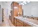 Bathroom vanity with wooden cabinets, white sink, and a large mirror at 5396 Splendido Ave, Pahrump, NV 89061