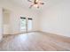 An empty bedroom with wood-look tile flooring, a ceiling fan, and french doors to the outside at 5396 Splendido Ave, Pahrump, NV 89061