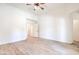 Large empty bedroom with light wood-look floors, white walls and ceilings, and simple crown molding at 5396 Splendido Ave, Pahrump, NV 89061