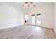 A spacious bedroom with wood-look flooring and french doors to the outside at 5396 Splendido Ave, Pahrump, NV 89061