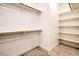 Walk-in closet with built-in shelving and wooden rods at 5396 Splendido Ave, Pahrump, NV 89061