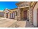Charming single-story home featuring stone accents, a tile roof, and double door entry at 5396 Splendido Ave, Pahrump, NV 89061