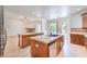 Open-concept kitchen, with views of the backyard pool through the sliding glass doors and the living room fireplace at 5396 Splendido Ave, Pahrump, NV 89061