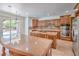 A spacious kitchen featuring wood cabinets, granite countertops, stainless steel appliances, and tile flooring at 5396 Splendido Ave, Pahrump, NV 89061