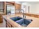 Close up of the kitchen island's sink and countertop, showing the modern faucet and the stone texture at 5396 Splendido Ave, Pahrump, NV 89061