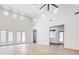 Bright and airy living room with tall ceilings, wood-look flooring, and French doors at 5396 Splendido Ave, Pahrump, NV 89061