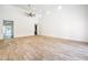 Spacious living room with vaulted ceiling, wooden-look tile flooring, and neutral paint scheme at 5396 Splendido Ave, Pahrump, NV 89061