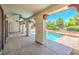 Inviting covered patio with decorative columns overlooks a sparkling pool and lush landscaping at 5396 Splendido Ave, Pahrump, NV 89061