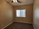 Empty bedroom with carpet flooring, ceiling fan and a bright window at 5605 Midnight Breeze St, North Las Vegas, NV 89081