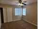 Carpeted bedroom featuring a ceiling fan, and natural light from two windows at 5605 Midnight Breeze St, North Las Vegas, NV 89081