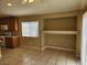 Kitchen area complete with built-in shelves, ample storage space, a sliding glass door, and tile flooring at 5605 Midnight Breeze St, North Las Vegas, NV 89081
