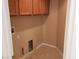 Laundry room with cabinets, beige walls, and tile flooring at 5605 Midnight Breeze St, North Las Vegas, NV 89081