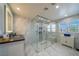 Modern bathroom features glass enclosed walk-in shower, marble floors, and granite counters at 5619 Shadow Bend Dr, Las Vegas, NV 89135