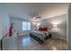 Cozy bedroom featuring wood-look flooring, ceiling fan, and two bedside tables with lamps at 5619 Shadow Bend Dr, Las Vegas, NV 89135