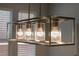 Modern kitchen chandelier with four lights surrounded by textured glass fixtures at 5619 Shadow Bend Dr, Las Vegas, NV 89135