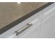 Granite countertop with white cabinetry and modern stainless steel pull at 5619 Shadow Bend Dr, Las Vegas, NV 89135