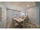 Elegant dining room with modern light fixture, seating for six, and stylish decor at 5619 Shadow Bend Dr, Las Vegas, NV 89135