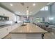 Open kitchen with an oversized island, stainless steel appliances, and views of the outdoor living space at 5619 Shadow Bend Dr, Las Vegas, NV 89135