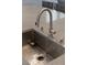 Modern stainless steel sink with a pull-down faucet and soap dispenser on a quartz countertop at 5619 Shadow Bend Dr, Las Vegas, NV 89135
