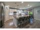 Spacious kitchen features an oversized island with seating for six, stainless appliances, and sliding doors at 5619 Shadow Bend Dr, Las Vegas, NV 89135