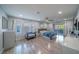 Spacious main bedroom with wood-look flooring, ceiling fan, and sliding glass door to a balcony at 5619 Shadow Bend Dr, Las Vegas, NV 89135