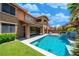 Inviting backyard pool features artificial turf and a covered patio area perfect for entertaining at 5619 Shadow Bend Dr, Las Vegas, NV 89135