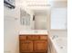 Bathroom with vanity sink, mirror, and soaking tub with a shower at 5641 Vassar Meadow St, Las Vegas, NV 89148