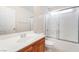 Bathroom showcasing a vanity with a single sink and a tub with a glass enclosure at 5641 Vassar Meadow St, Las Vegas, NV 89148