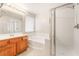 Bathroom features a soaking tub, glass-enclosed shower, vanity, and tile floors at 5641 Vassar Meadow St, Las Vegas, NV 89148