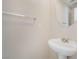 Half bathroom featuring a pedestal sink, vanity mirror, and chrome hardware at 5641 Vassar Meadow St, Las Vegas, NV 89148