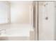 Bathroom showcasing a soaking tub next to a glass-enclosed shower and window at 5641 Vassar Meadow St, Las Vegas, NV 89148