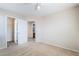 Bedroom with plush carpet, white trim, open doors to closet and bathroom at 5641 Vassar Meadow St, Las Vegas, NV 89148